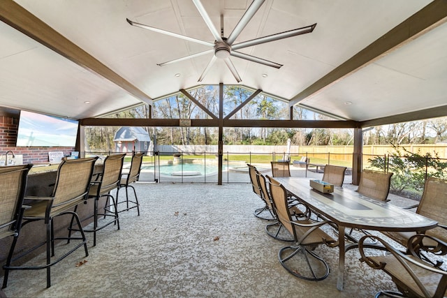 sunroom featuring lofted ceiling with beams