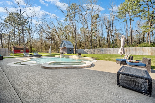 exterior space featuring an outdoor fire pit, a fenced backyard, an outbuilding, an in ground hot tub, and a shed