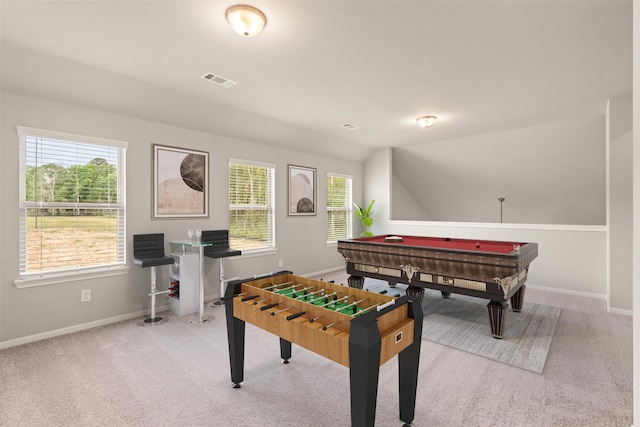 game room with baseboards, lofted ceiling, visible vents, and light colored carpet