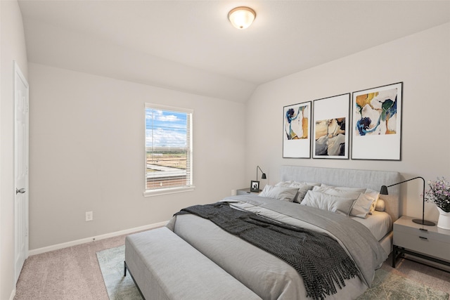 bedroom featuring carpet, vaulted ceiling, and baseboards