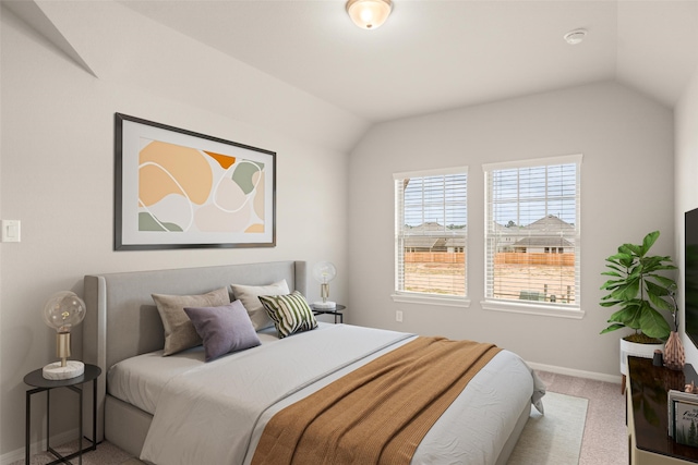 bedroom featuring carpet floors, baseboards, and vaulted ceiling