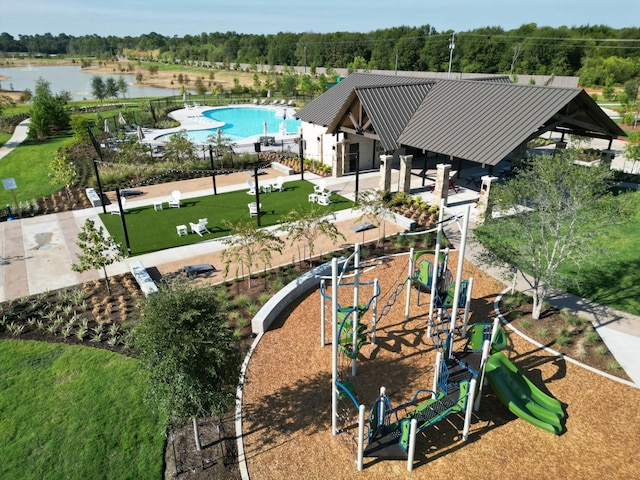 view of home's community with playground community and a water view