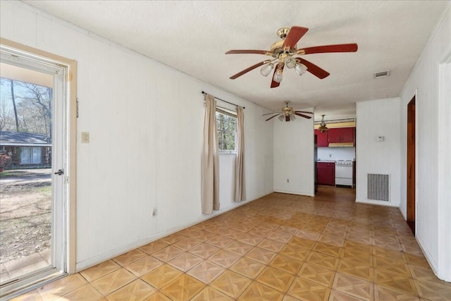 unfurnished room featuring visible vents