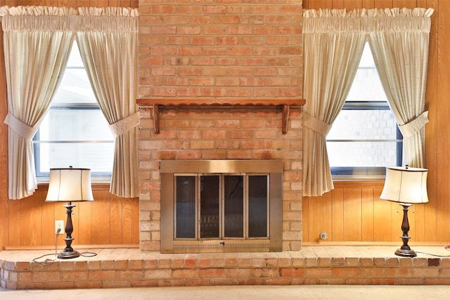 room details featuring wood walls and a fireplace