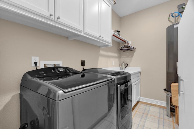 laundry room with cabinet space, washer and clothes dryer, and baseboards