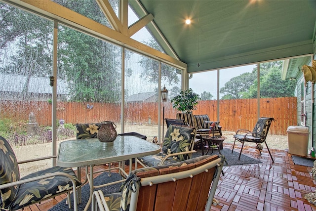 sunroom / solarium with lofted ceiling and plenty of natural light