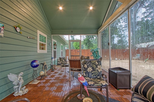 sunroom / solarium featuring lofted ceiling