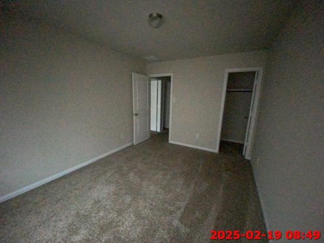 unfurnished bedroom featuring carpet and baseboards