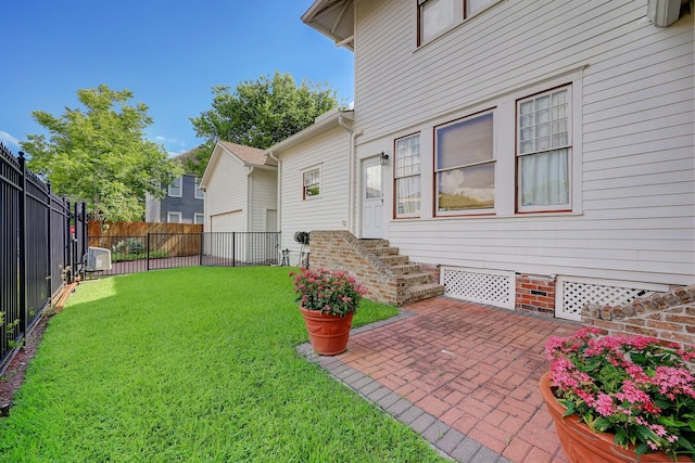 view of yard with entry steps, central AC, a garage, a fenced backyard, and a patio area