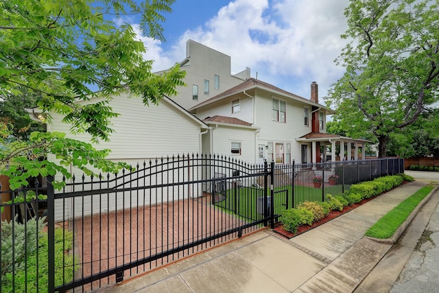 exterior space featuring a fenced front yard and a gate