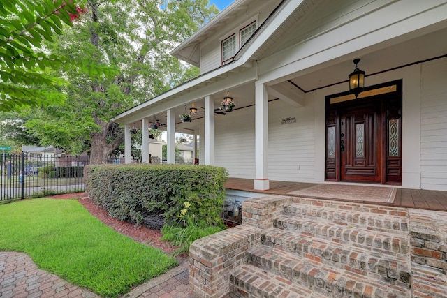 property entrance with a porch and fence