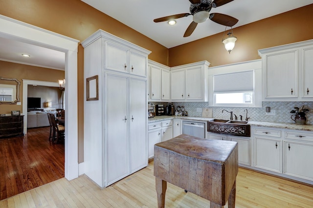 kitchen with tasteful backsplash, ceiling fan, dishwasher, light wood-style floors, and white cabinetry