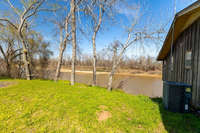 view of yard featuring a water view and cooling unit