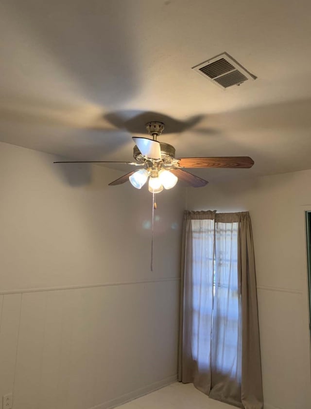 empty room with visible vents and a ceiling fan