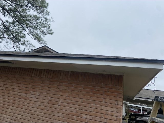 view of side of property featuring brick siding