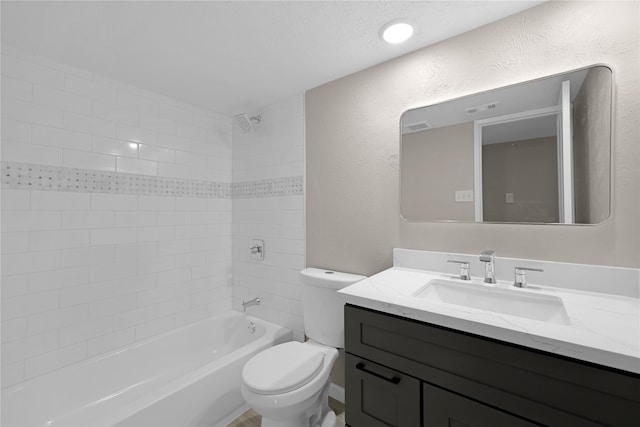 full bathroom with a textured wall, vanity, bathtub / shower combination, and toilet