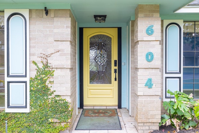 doorway to property with brick siding