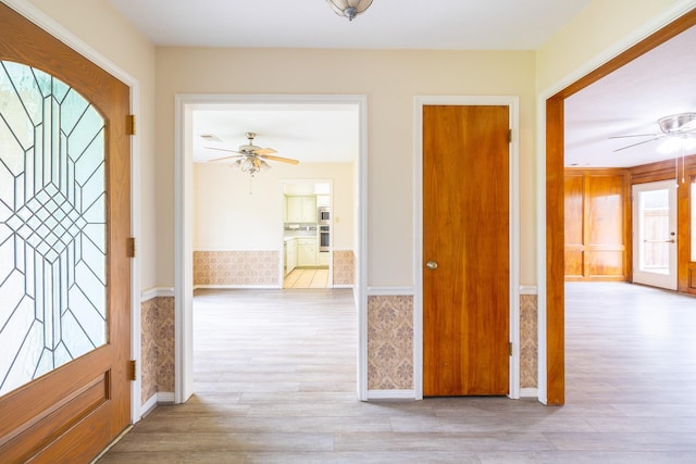 foyer with a ceiling fan and wood finished floors