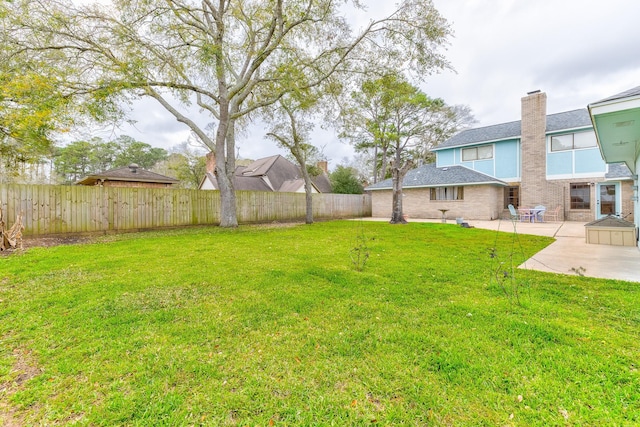 view of yard with a patio area and a fenced backyard