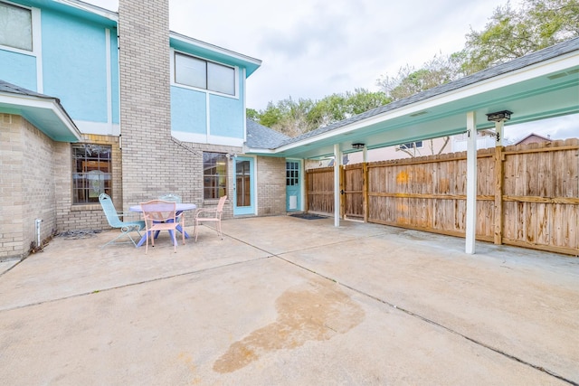 view of patio featuring fence