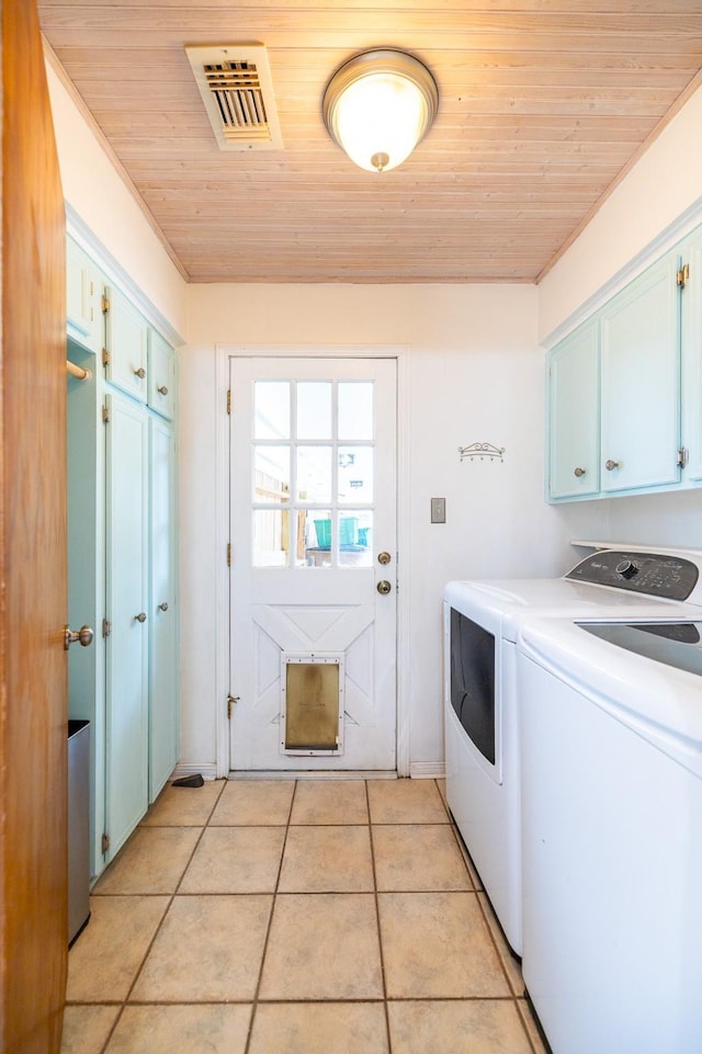 laundry room featuring washer and clothes dryer, light tile patterned floors, visible vents, cabinet space, and wooden ceiling