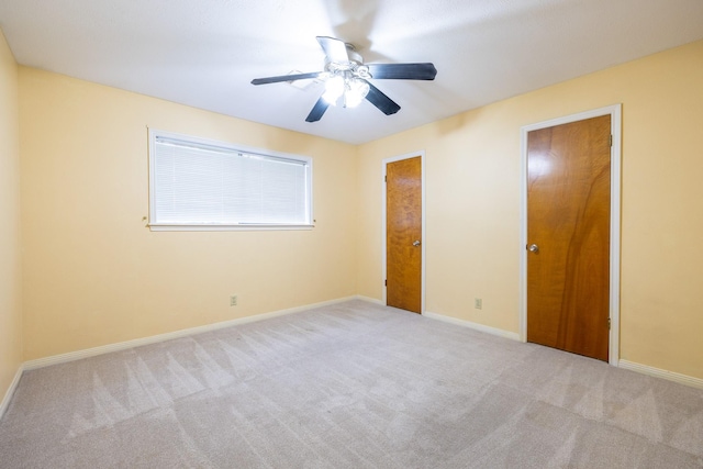 unfurnished bedroom with a ceiling fan, carpet flooring, and baseboards