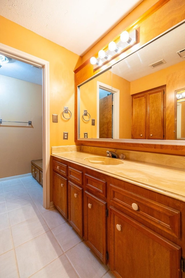 bathroom featuring visible vents, vanity, and tile patterned floors