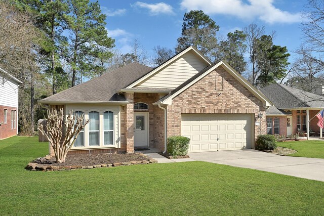 3520 White Oak Point Dr, Conroe, TX 77304 - ranch-style house with brick siding, an attached garage, concrete driveway, and a front lawn