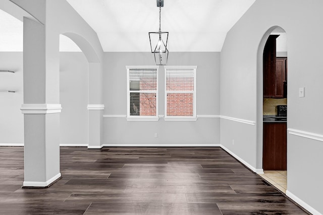 3520 White Oak Point Dr, Conroe, TX 77304 - unfurnished dining area with arched walkways, wood finished floors, and vaulted ceiling