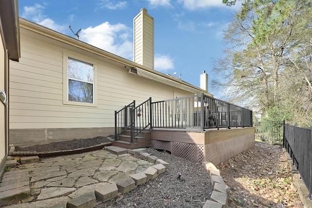 3520 White Oak Point Dr, Conroe, TX 77304 - back of property with a deck, a patio area, fence, and a chimney