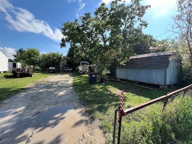 view of road with gravel driveway