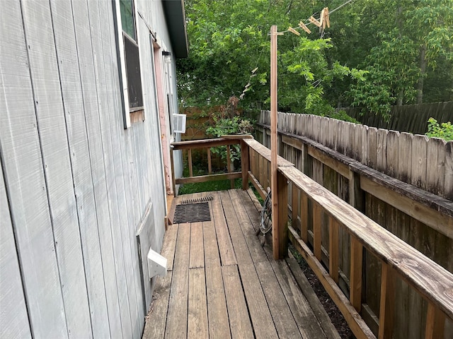 wooden terrace featuring fence