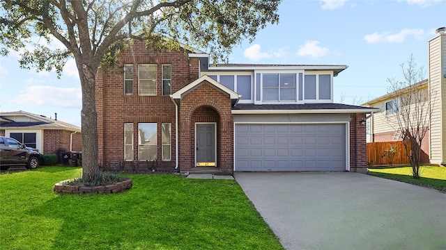 traditional-style house featuring driveway, fence, an attached garage, a front yard, and brick siding