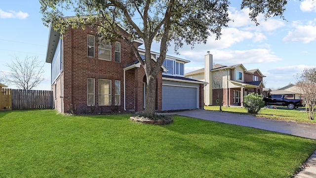 traditional-style house featuring brick siding, fence, aphalt driveway, a front yard, and an attached garage