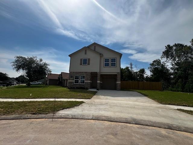 view of front facade with an attached garage, driveway, a front yard, and fence