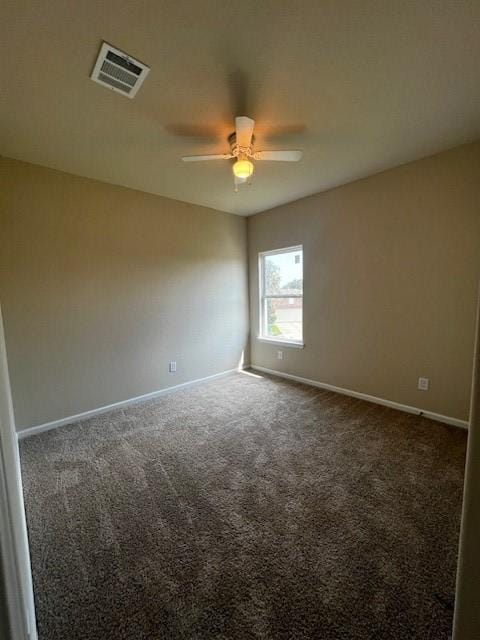 carpeted spare room with ceiling fan, visible vents, and baseboards