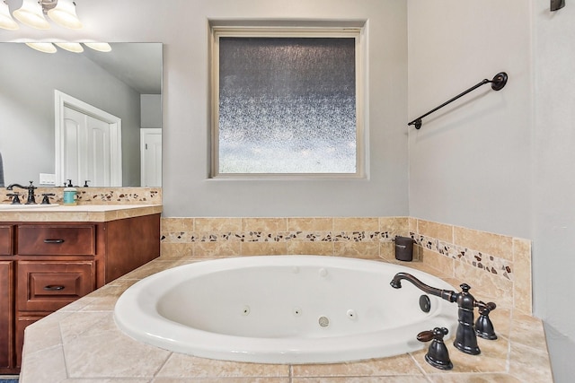 bathroom featuring a tub with jets and vanity