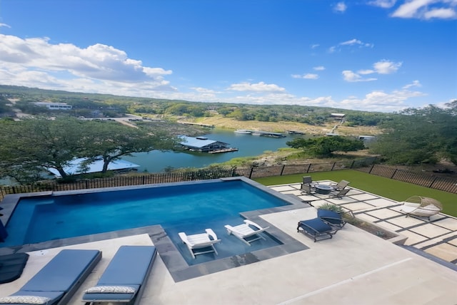 view of swimming pool featuring a fenced in pool, a patio area, a water view, and fence