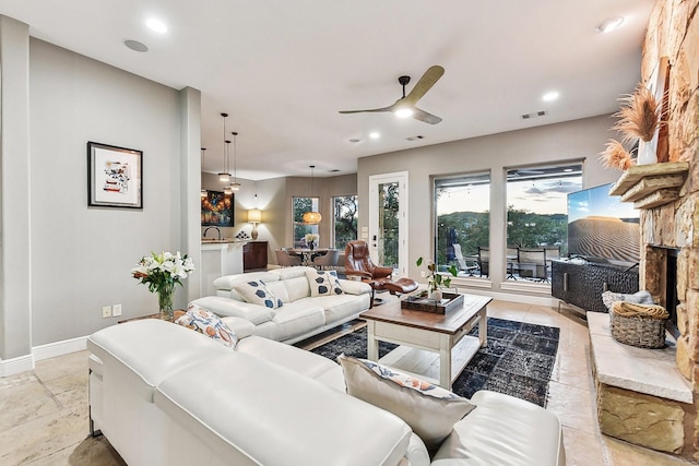 living area with a ceiling fan, recessed lighting, visible vents, and baseboards