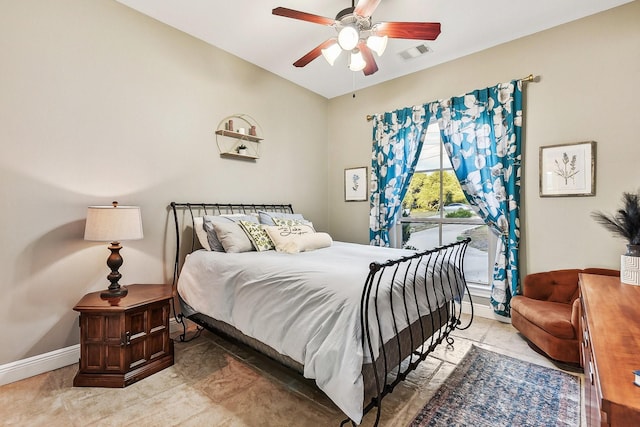 bedroom featuring a ceiling fan, visible vents, and baseboards