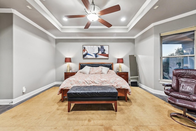 bedroom featuring crown molding, a raised ceiling, a ceiling fan, and baseboards