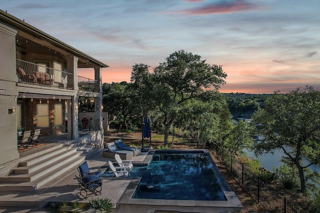 pool with fence and a patio