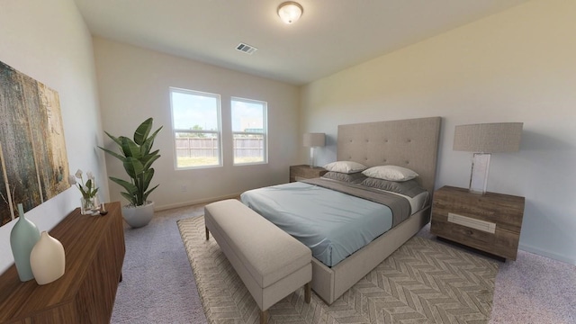 bedroom featuring light carpet, baseboards, and visible vents