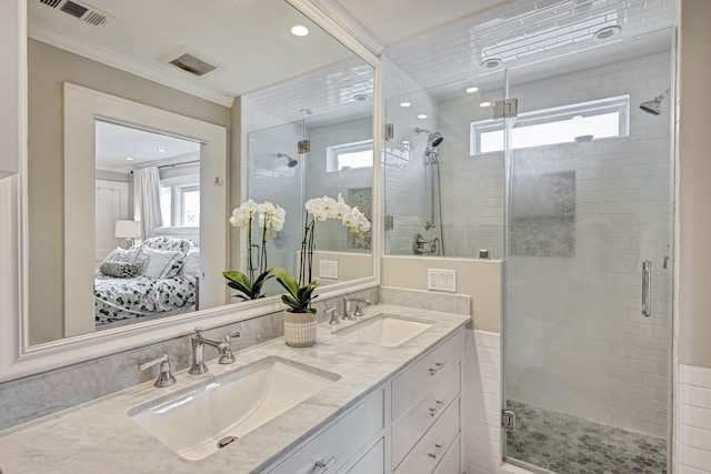 full bath featuring double vanity, connected bathroom, visible vents, and a sink