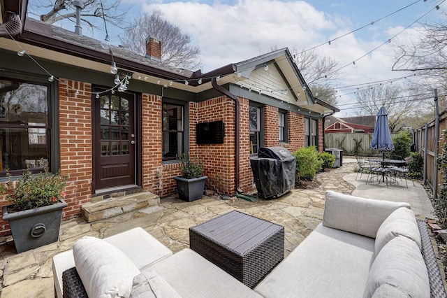 view of patio / terrace with outdoor dining area, fence, area for grilling, and an outdoor hangout area