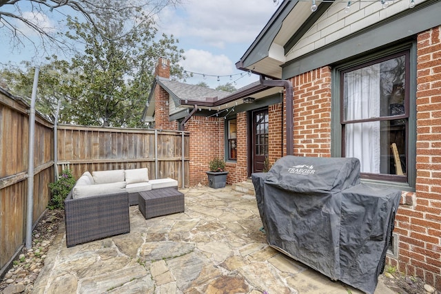 view of patio / terrace with a fenced backyard, area for grilling, and an outdoor hangout area