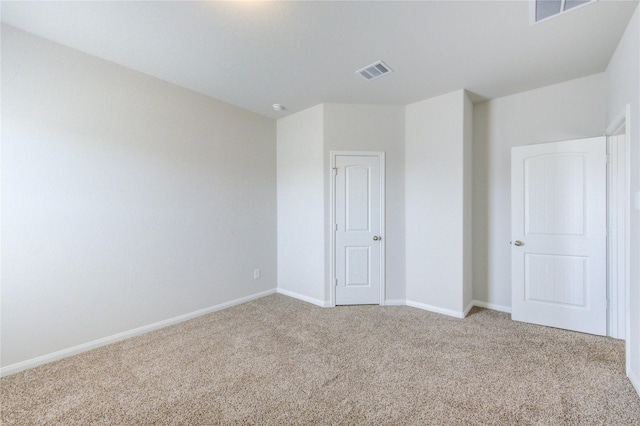 unfurnished bedroom featuring baseboards, visible vents, and light colored carpet