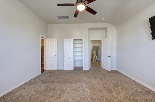 unfurnished bedroom with carpet floors, visible vents, vaulted ceiling, ceiling fan, and baseboards