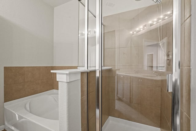 full bath featuring a garden tub, a shower stall, visible vents, and vanity