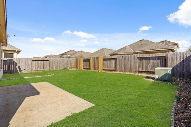 view of yard featuring a patio area and a fenced backyard